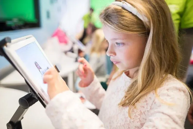 Girl learning with a tablet at the Museum of London.