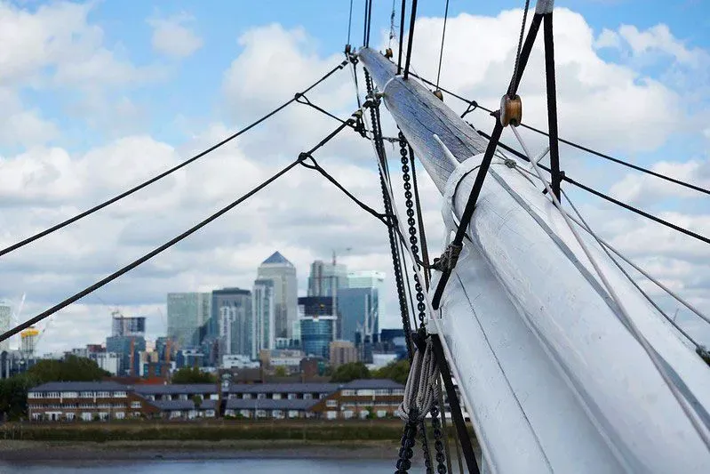 View of London skyline from close-up of the Cutty Sark's helm.