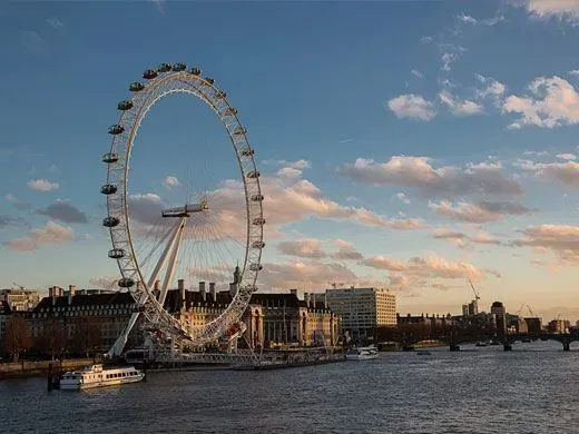View of the London Eye at sunset from Hungerford Bridge.