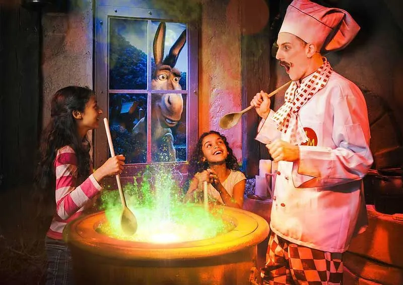 two children with character at shrek's adventure