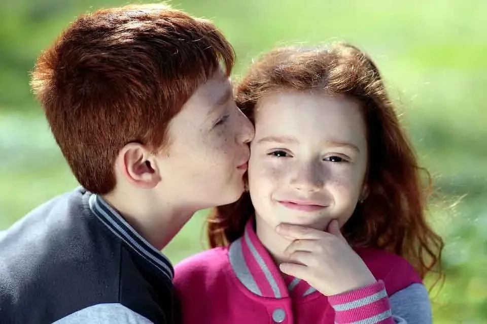 An affectionate brother and sister who have natural red hair are a strong pair.