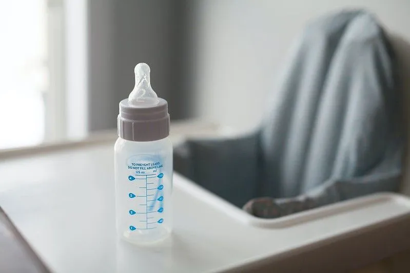 Baby bottle on high chair.