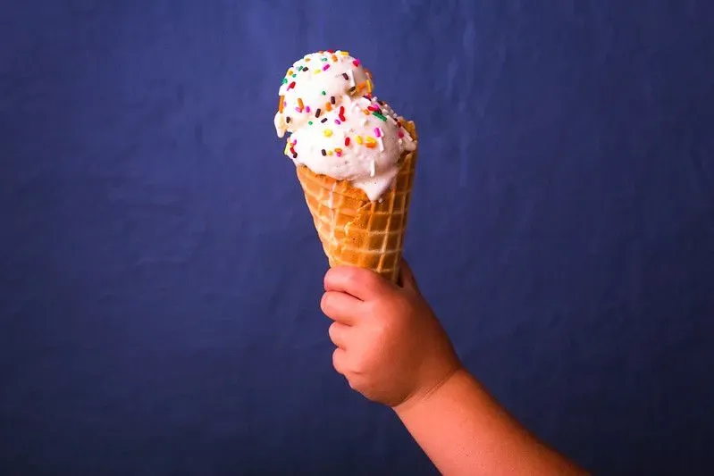 Child's hand holding an ice cream