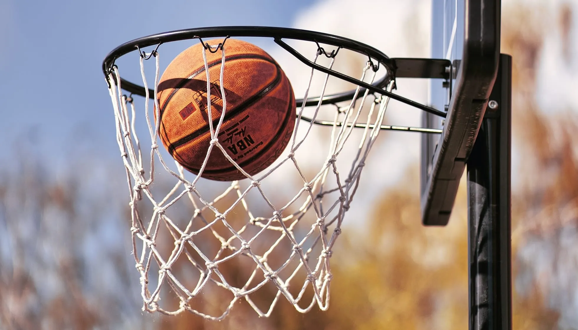Close up of a basketball in the basket