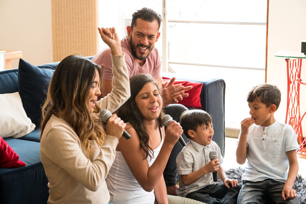 A family sings karaoke during a Singa session.