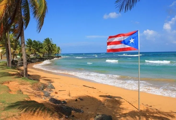 Flag of Puerto Rico waving on the beach