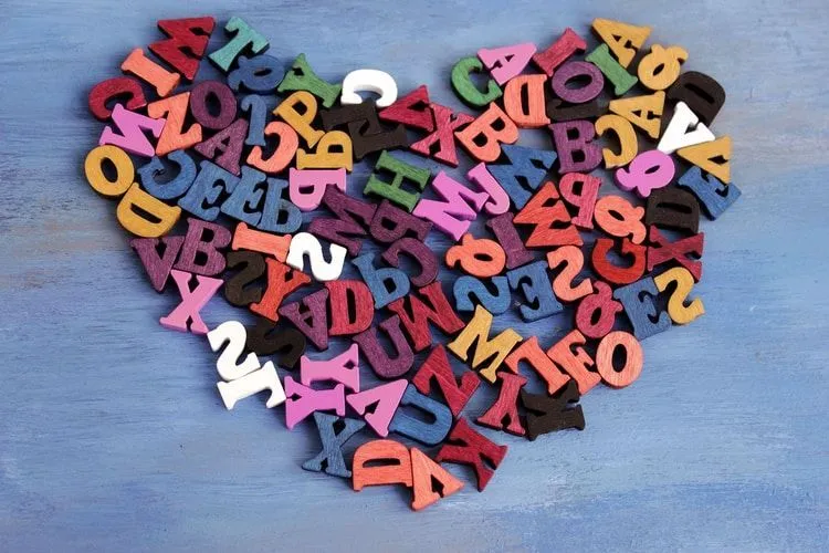 Colorful wooden blocks of alphabets arranged in a shape of heart