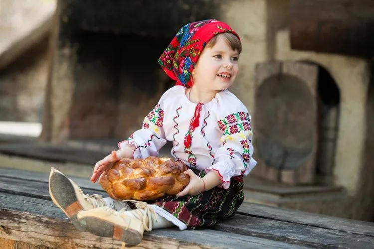 Little girl in traditional Romanian folk costume with embroidery.
