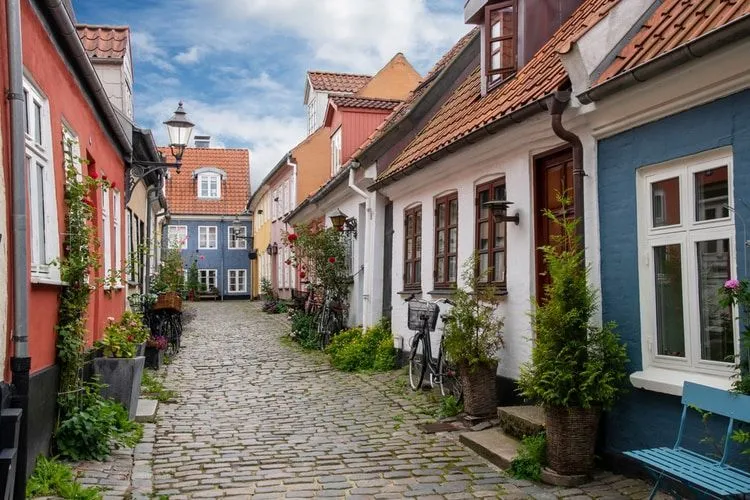 View down the cobblestone street of Hjelmerstald, the historic preserved neighborhood of Aalborg, Denmark
