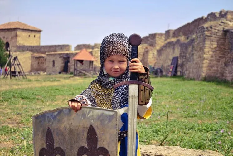A girl dressed as a warrior holding sword and shield