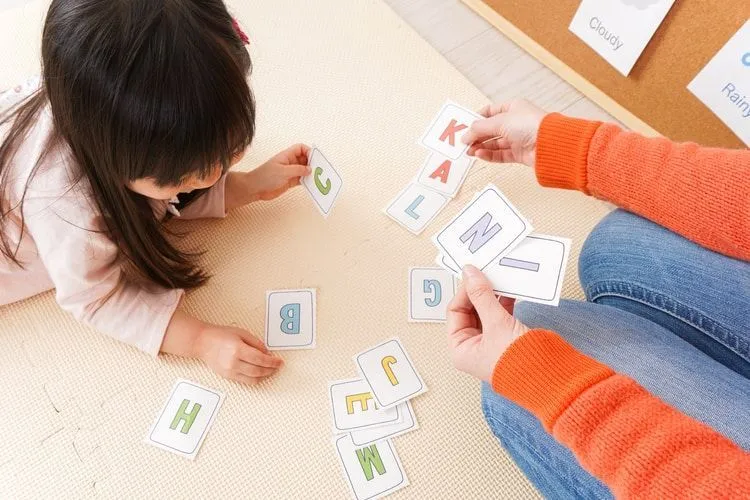 A girl learning alphabet with cards