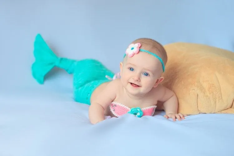 A newborn baby dressed as a mermaid