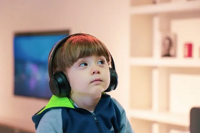A little boy wearing a headphone