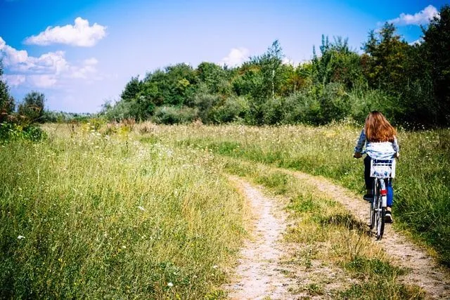 A girl riding bicycle in the meadow