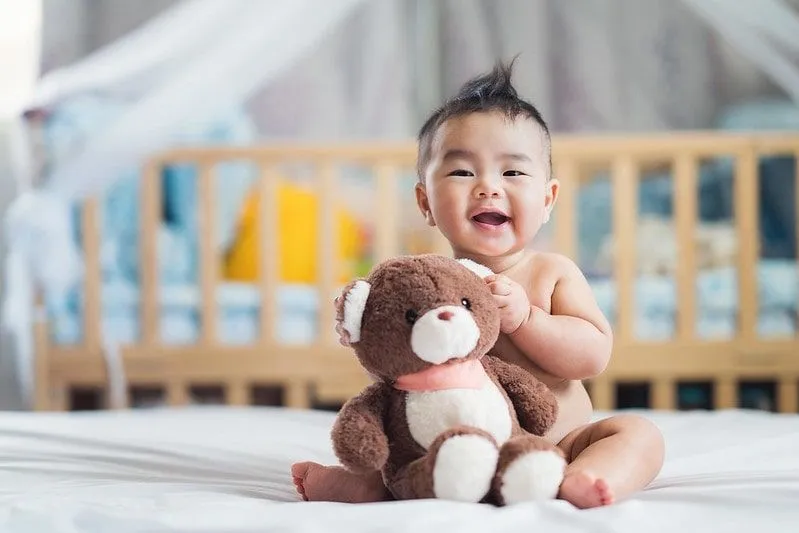 A newborn baby boy with teddy bear