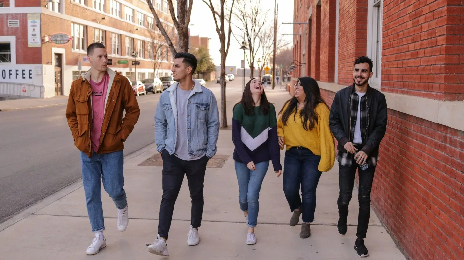 Five friends walking on the street 