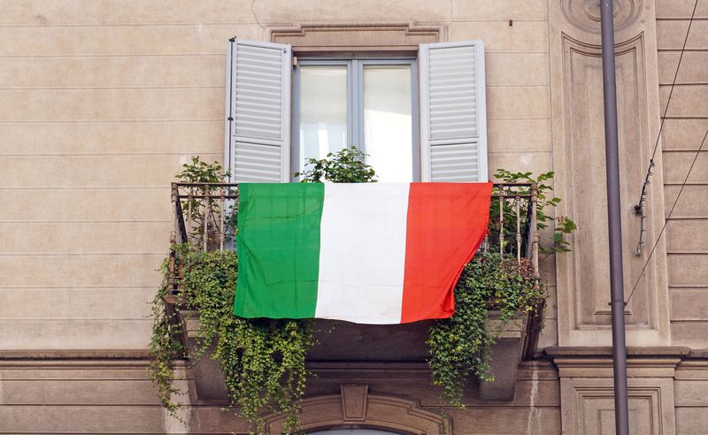 Flag of Italy hanging on the balcony.