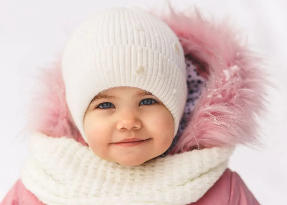A cool girl wearing pink furry winter clothes
