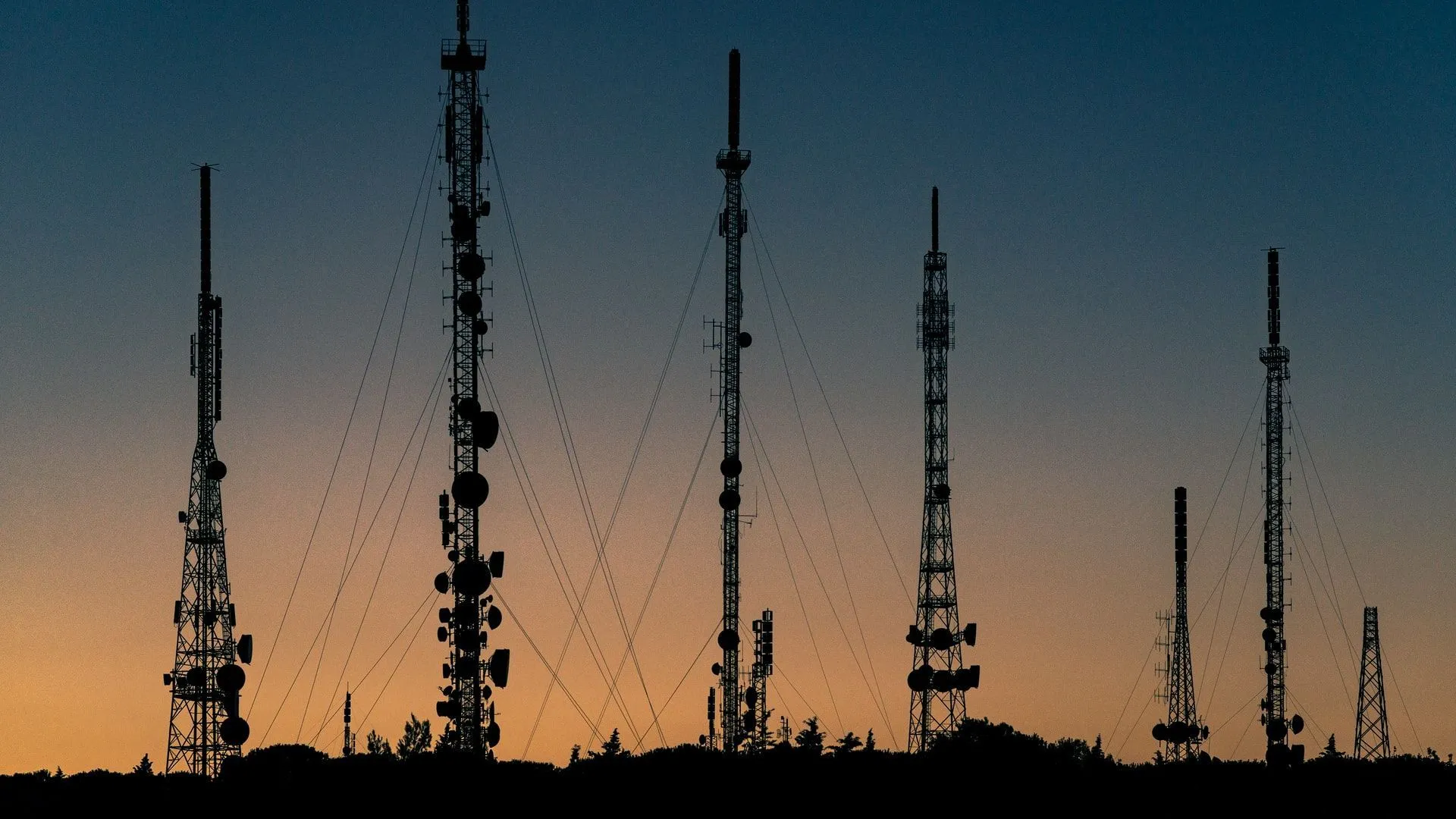 A group of radio towers in the Italian countryside.