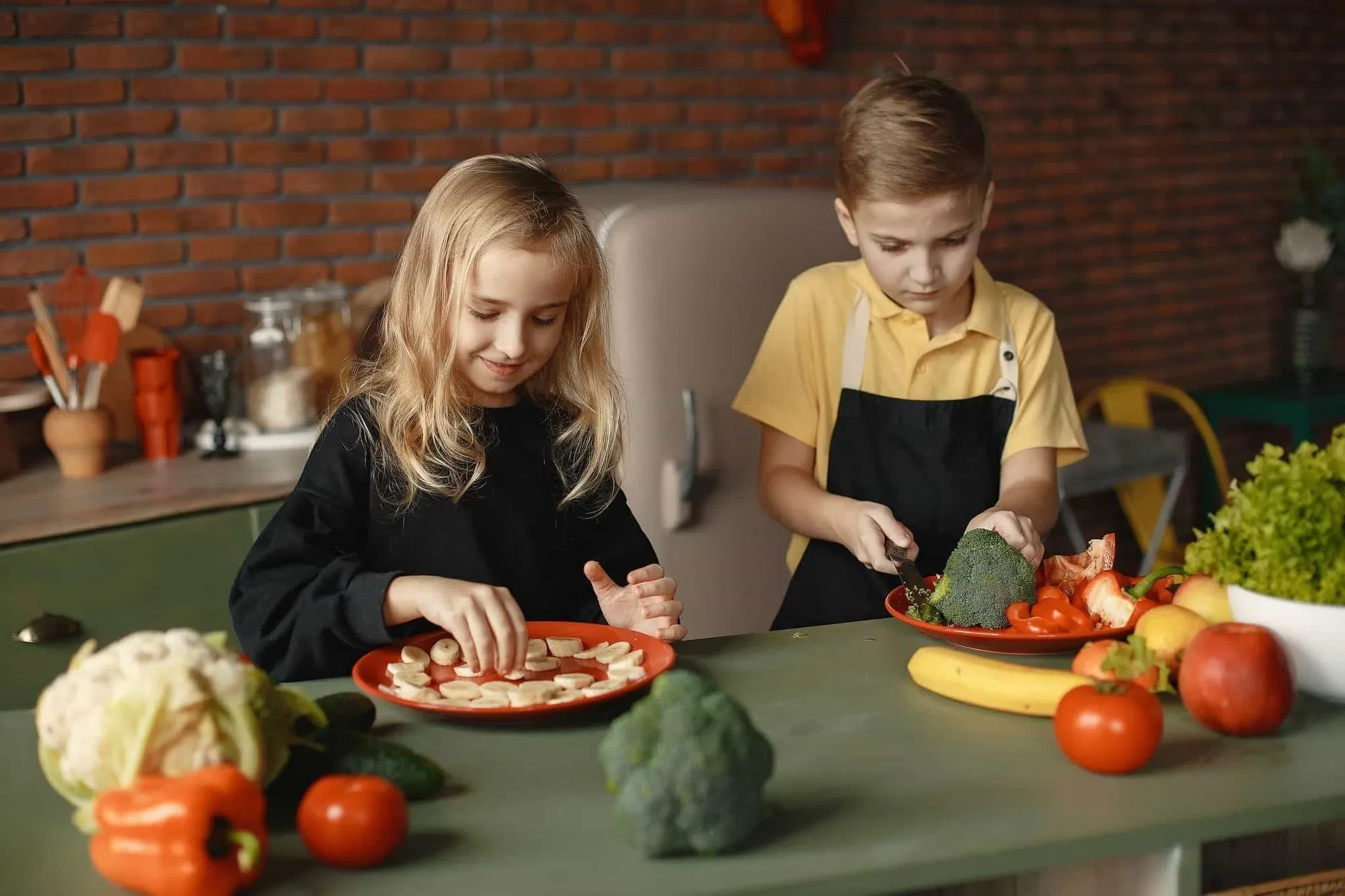 Brother and sister preparing lunch in the kitchen.