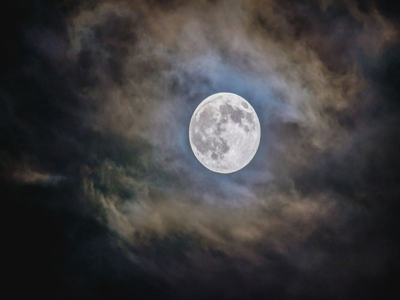 Bright full moon with cloudy background at the night time
