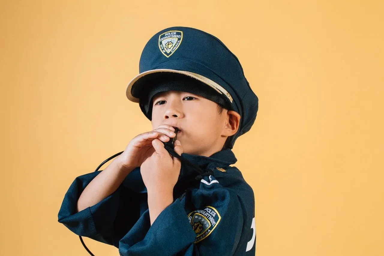 A little boy wearing police costume