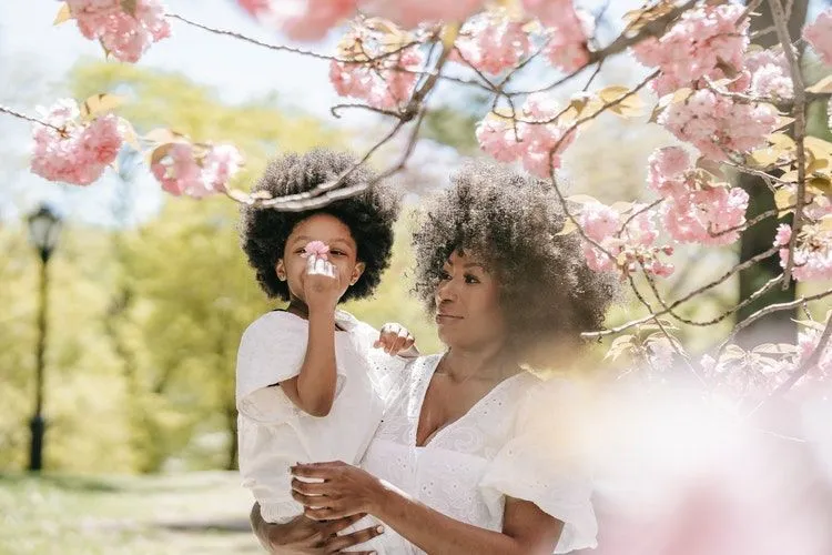 Mother and daughter under a pink flower tree