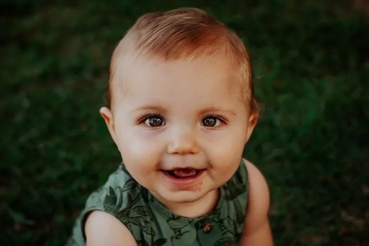 A happy toddler looking at the camera