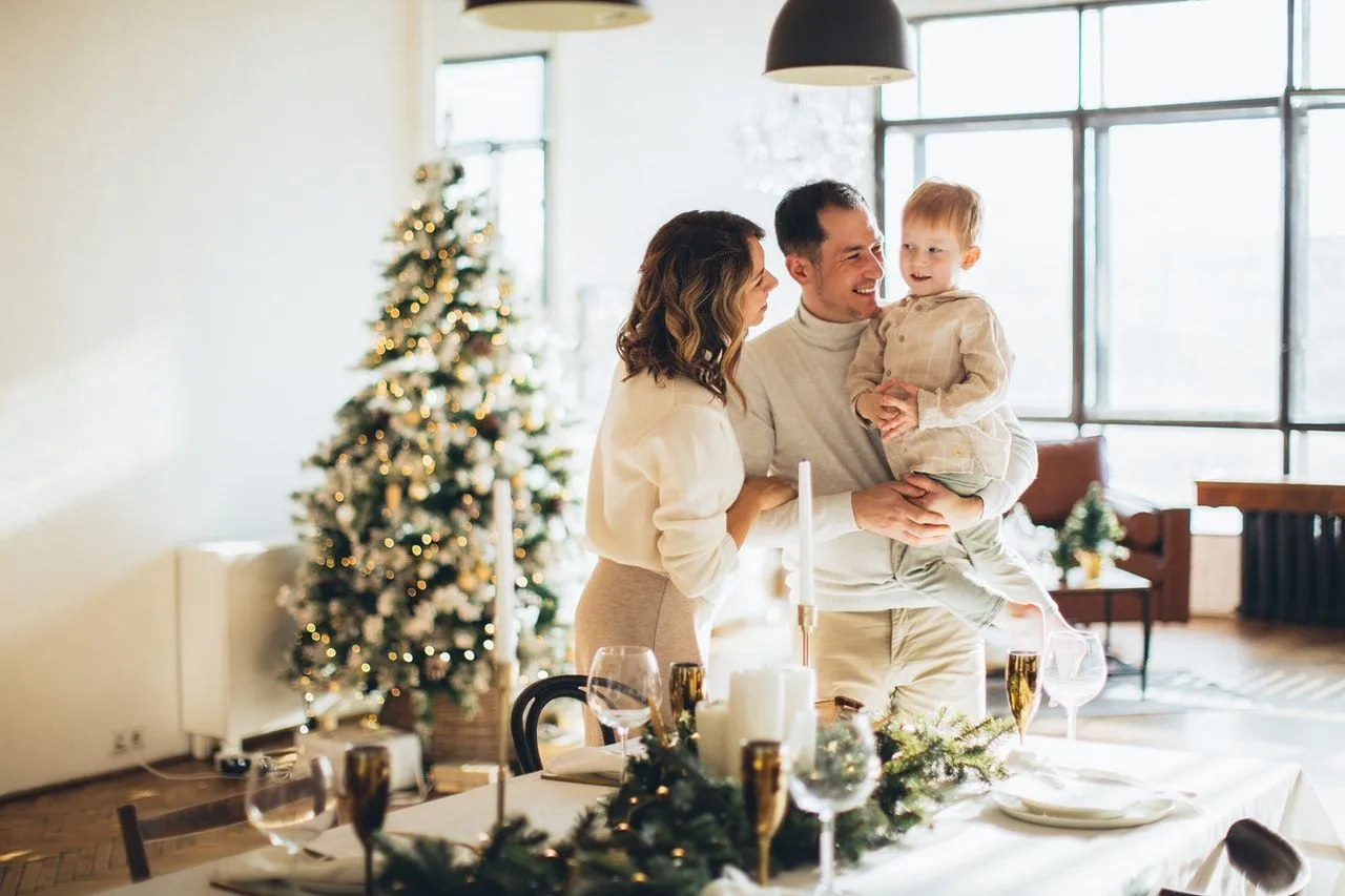 Family of three inside their home enjoying Christmas