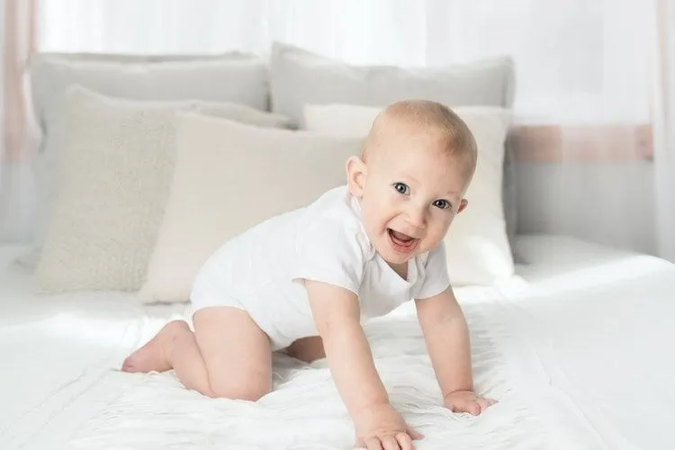 A happy baby on bed