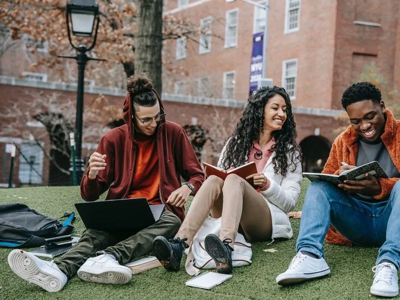 Three multiethnic students studying on the university campus