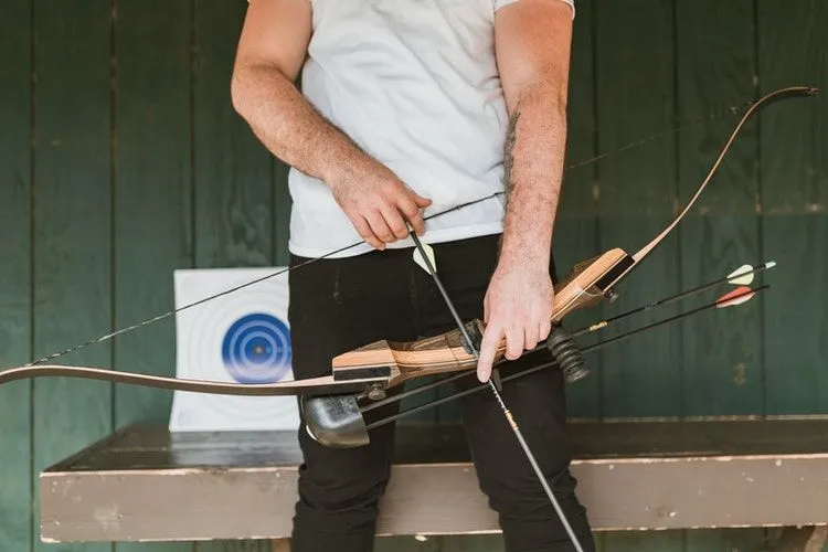A man holding bow and arrow