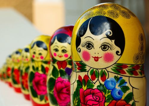 Colourful Russian nesting dolls aligned in a straight line