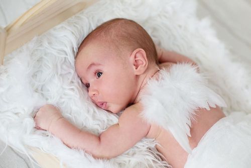 A newborn angel baby with white wings