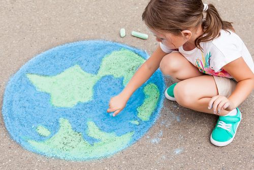 Girl drawing the earth as part of the geography games