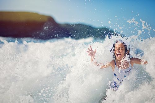 Young girl having fun in the waves.
