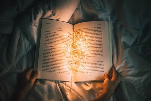 An open book with fairy lights.