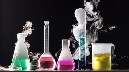 Science tubes and beakers bubbling and smoking with vibrant colours.