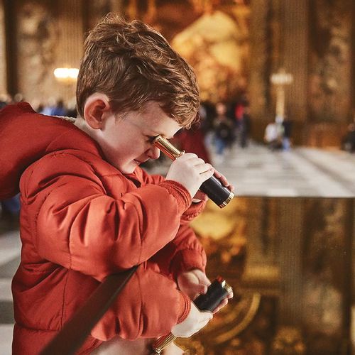 Child at the Painted Hall looking around