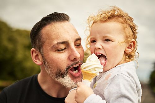 A father and toddler enjoying their homemade ice cream.