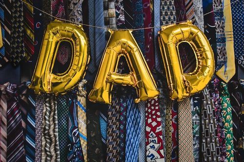 Gold balloons spelling out 'dad' in capital letters.