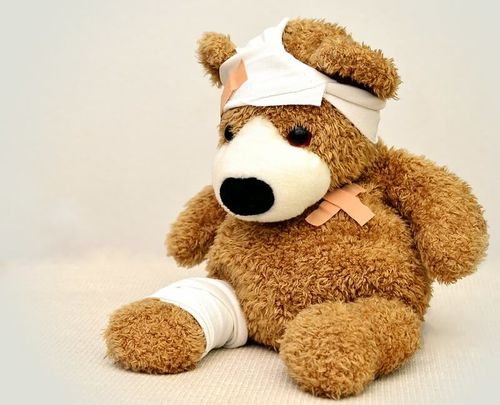 Bandaged bear demonstrating baby first aid equipment for the baby first aid checklist.
