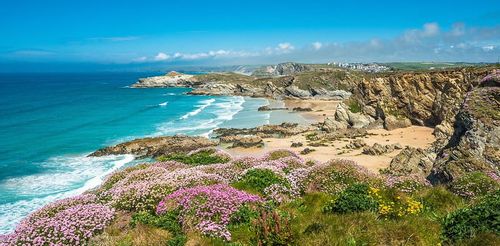 The beach in Newquay, Cornwall on a sunny day, perfect for a staycation.