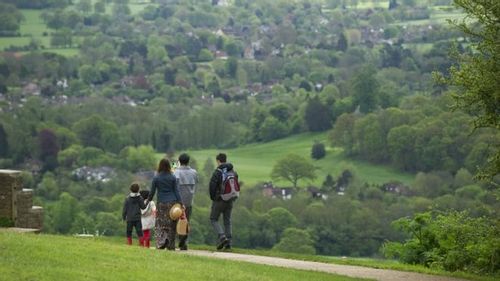 Family on a hike on Box Hill, a great climb on the edge of London.