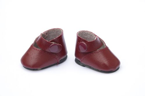 A pair of vintage baby doll's red leather shoes.