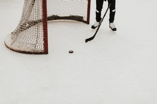Close up of an ice hockey goalkeeper and the net