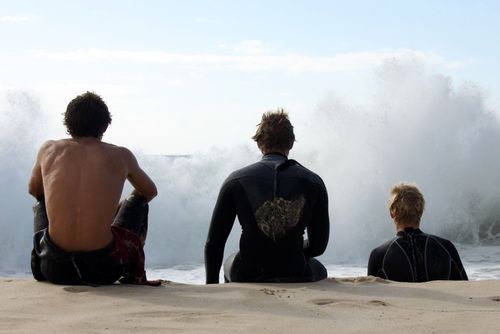 Three Australian boys sitting on the beach