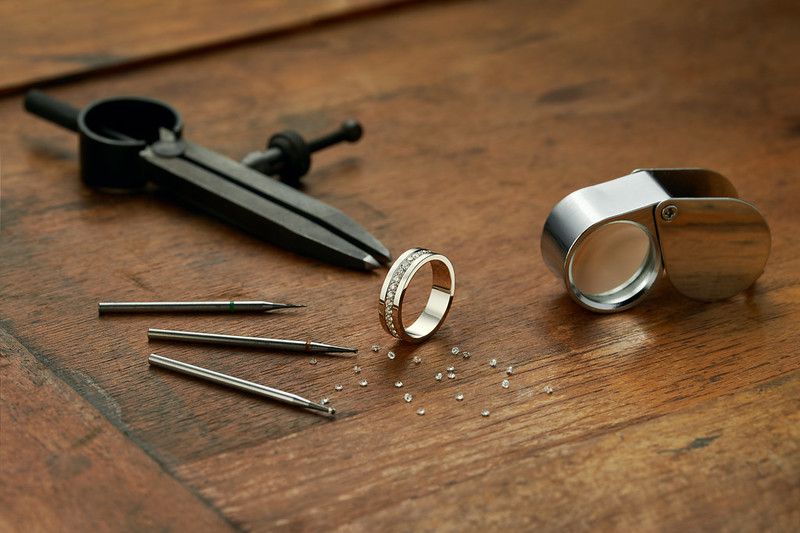 Workplace of a jeweler with tools making White gold ring